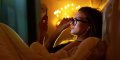 woman-in-bed-listening-to-music-on-smartphone-headphones-750x375.jpg